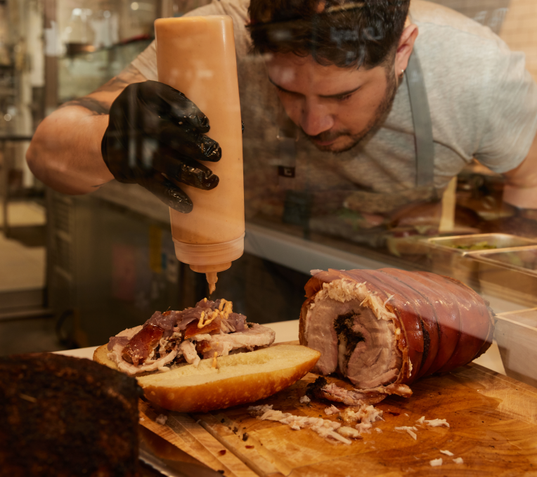 Freebird chef creating tasty meat sandwich